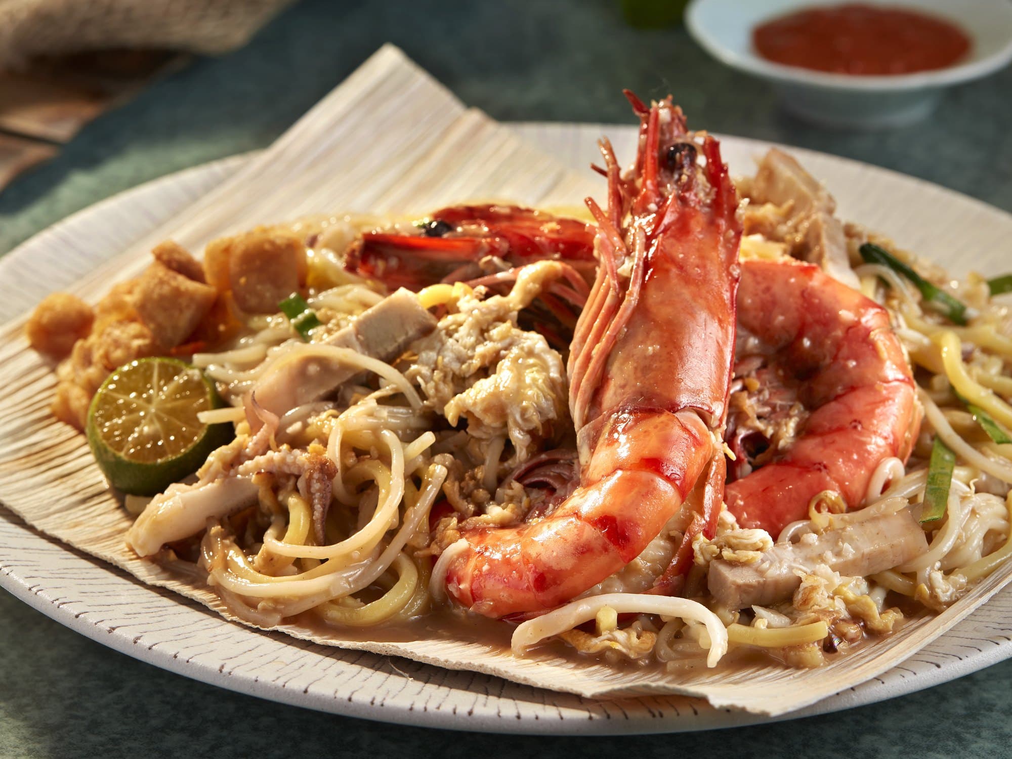 First Street fried prawn noodles with a whole prawn on banana leaf