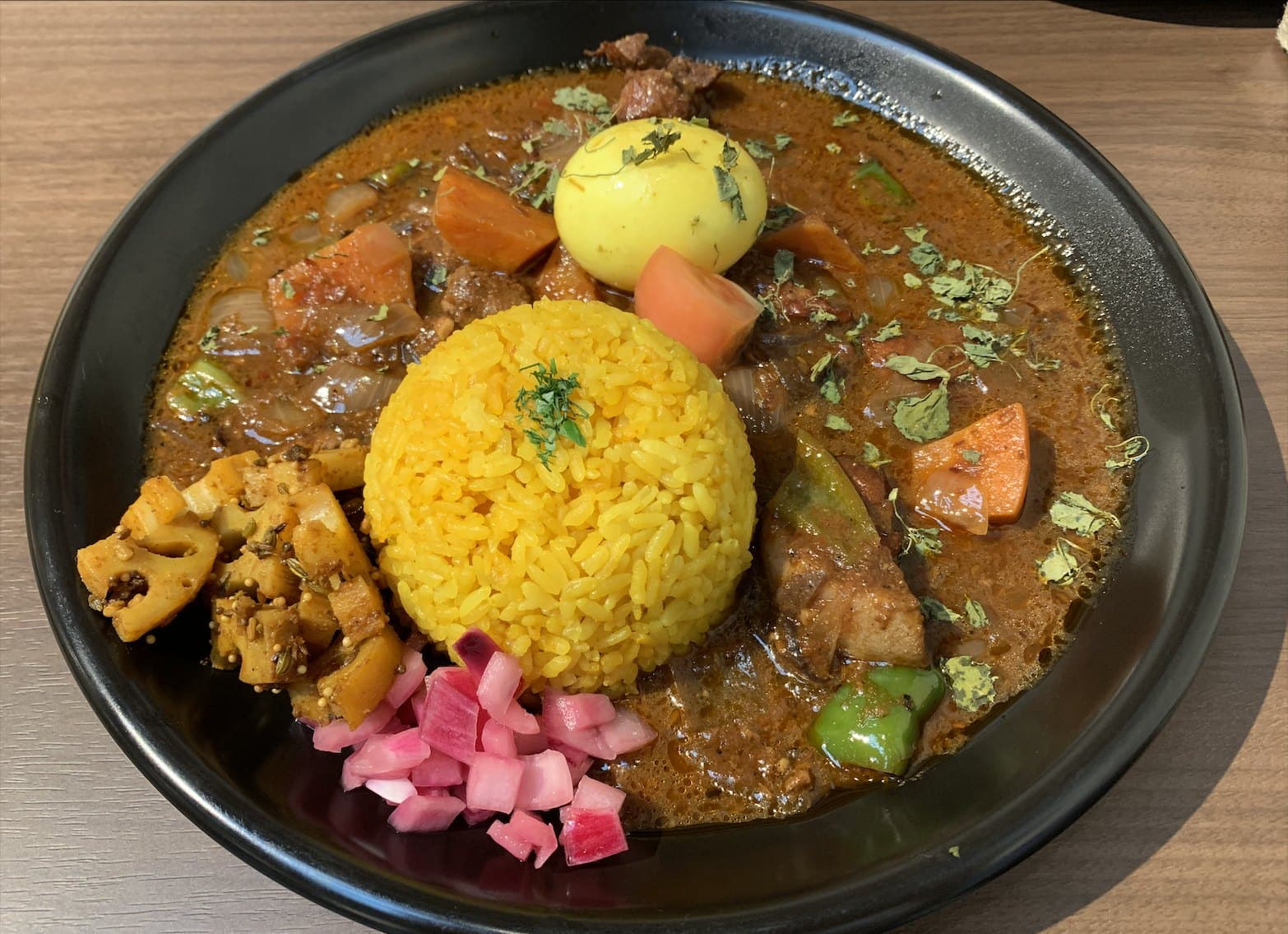 Japanese curry and rice with vegetables, egg, and pickles