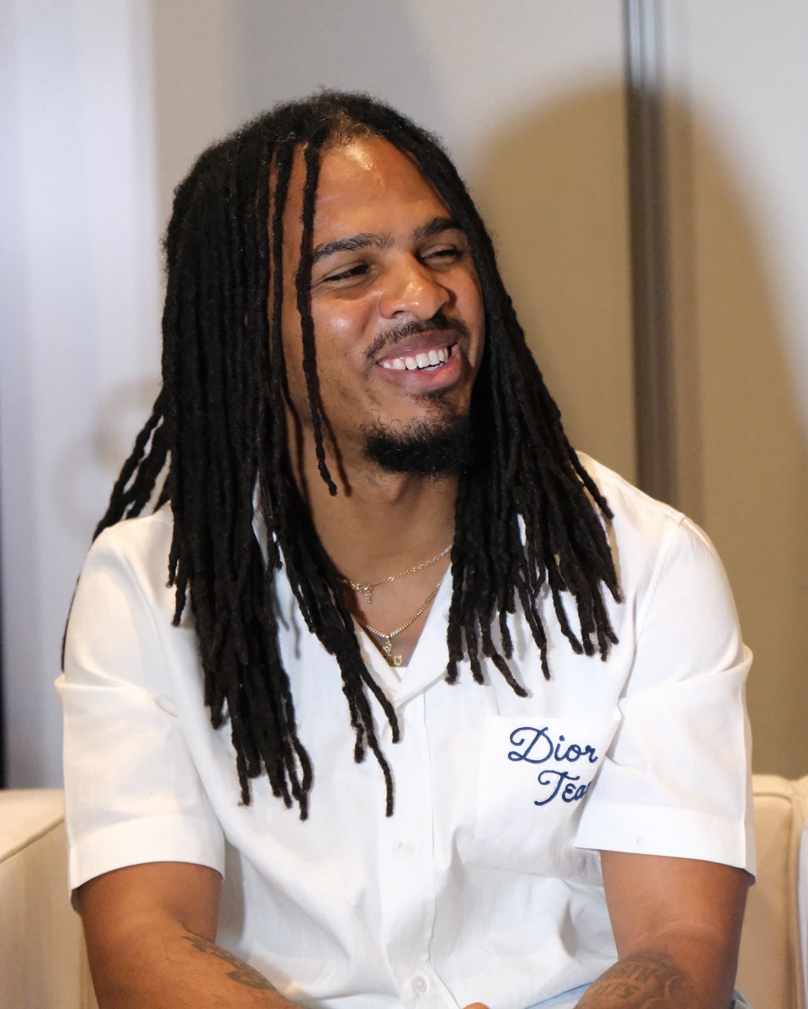 Keith Lee smiling in a white shirt at the Essence Festival of Culture in 2025