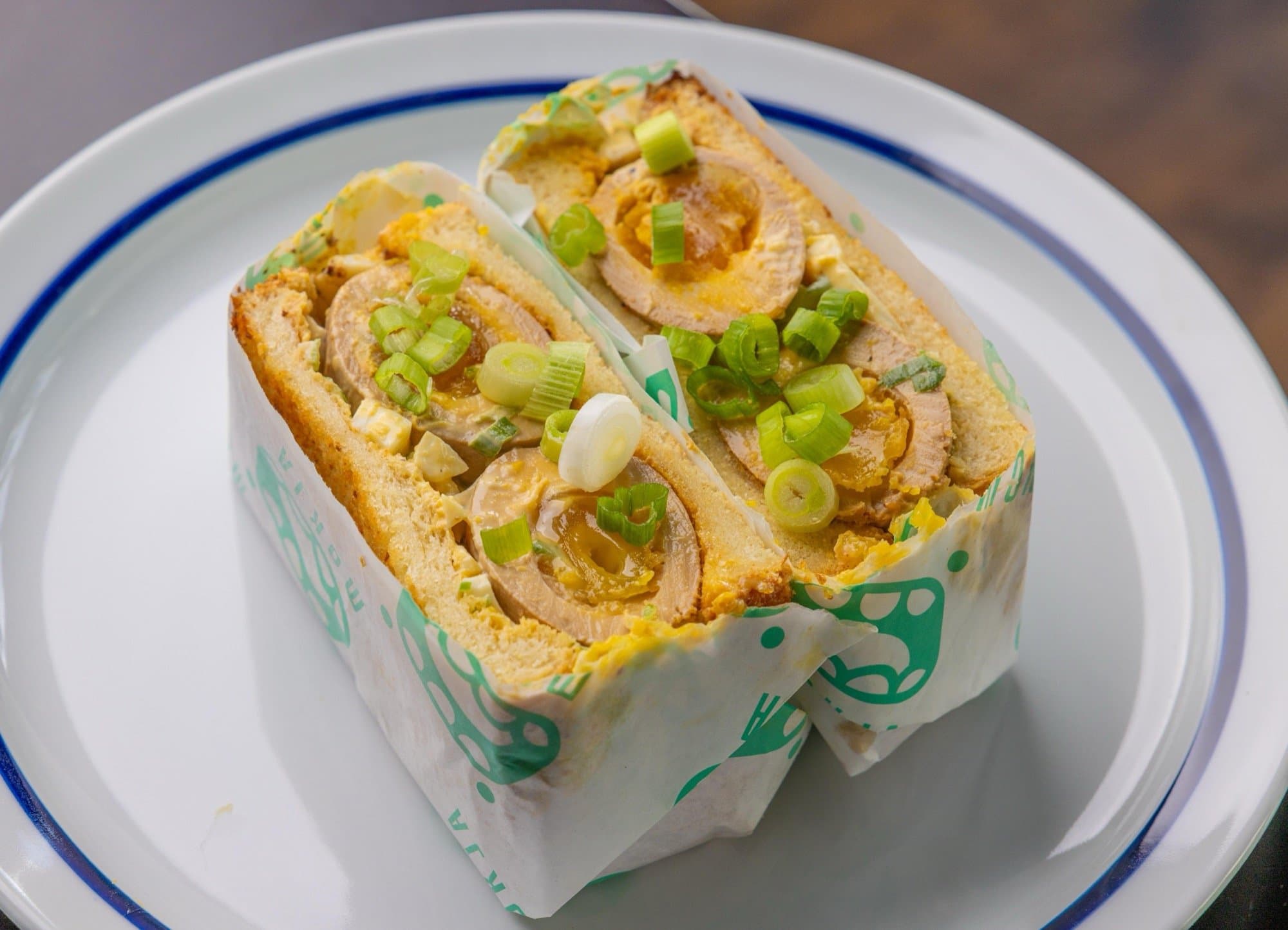 Mayak egg salad sandwich on thick milk bread, filled with marinated soft egg, scallions, and sesame