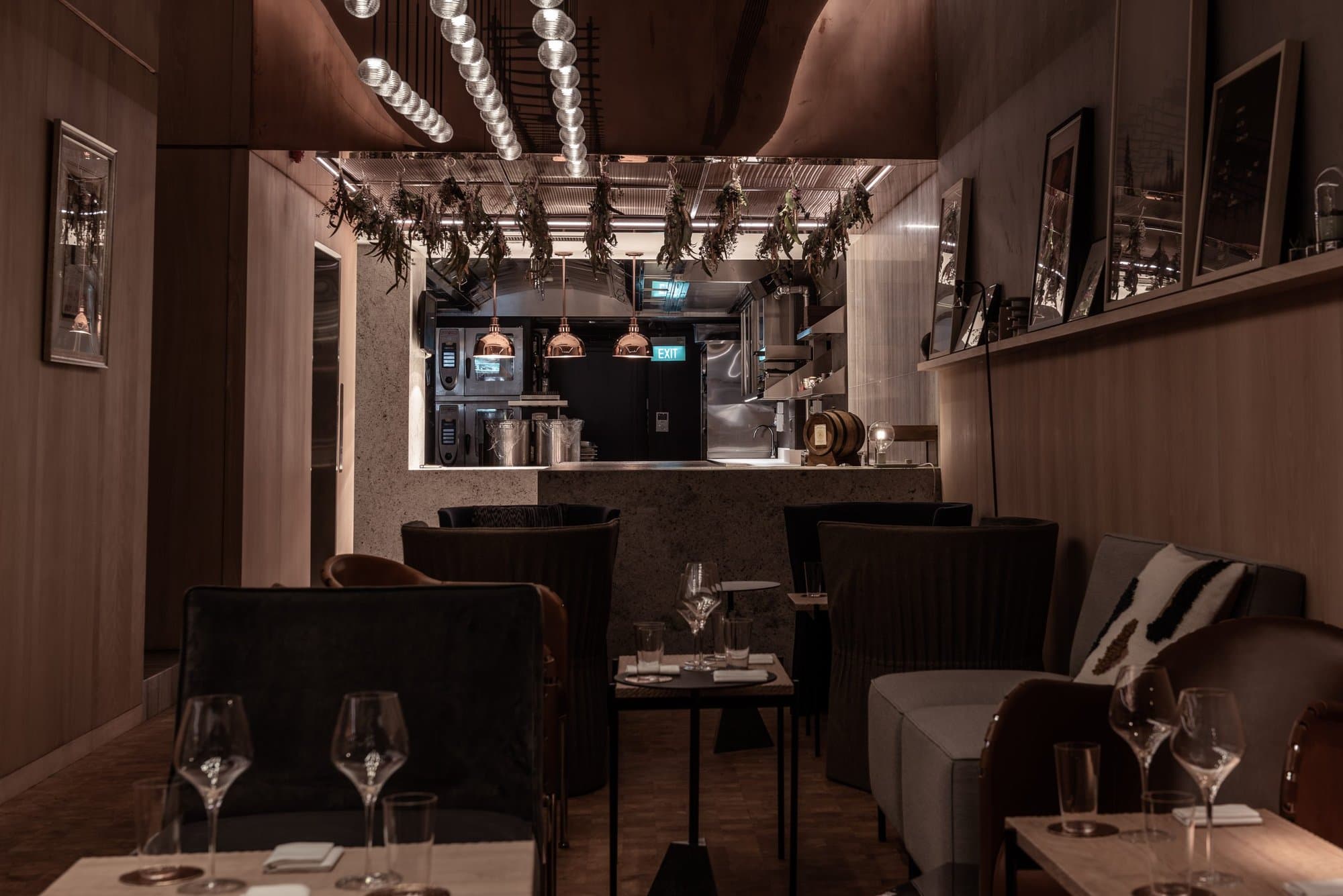 Warm Restaurant Zen dining room with counter beyond and tables set for service