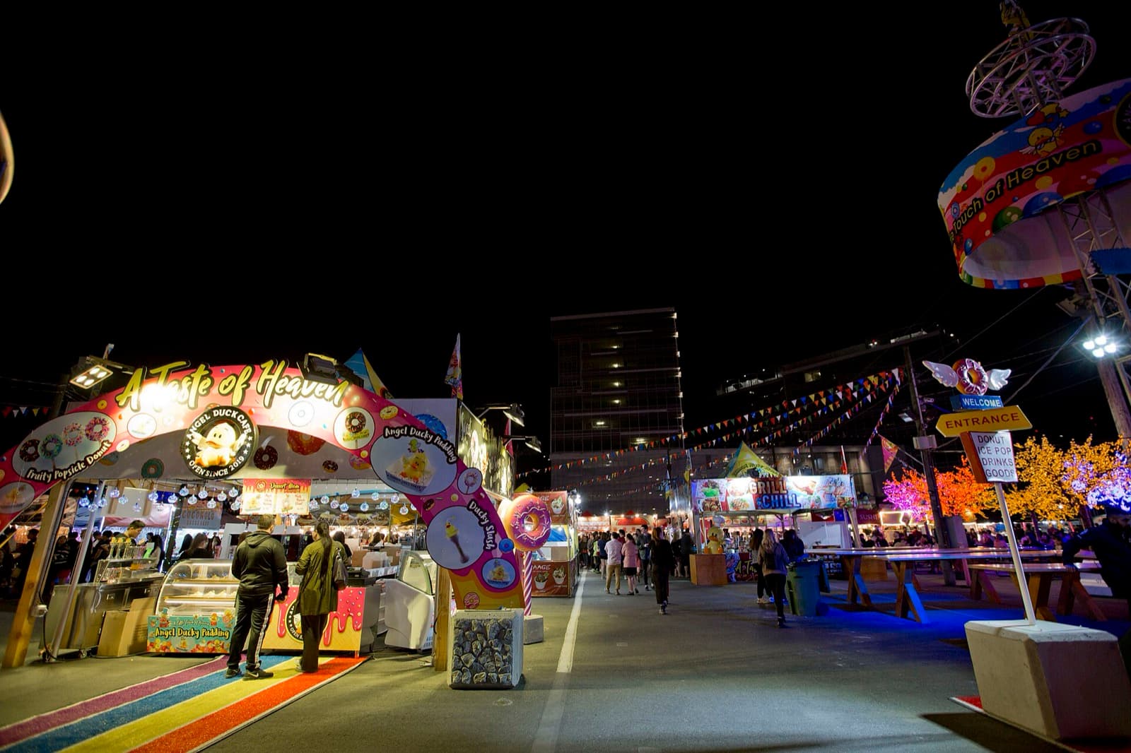 Evening crowds walking among food stalls at the Richmond Night Market in British Columbia