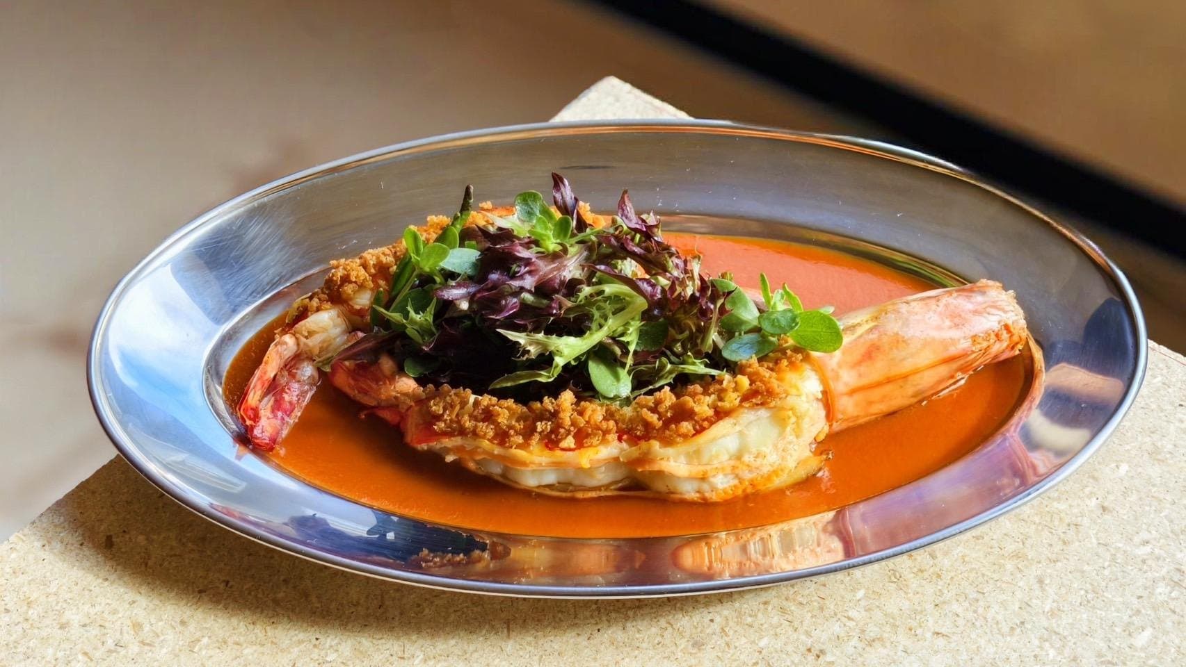 Tiger prawn with shrimp paste, fava beans, and herbs in a metal tray at Saam