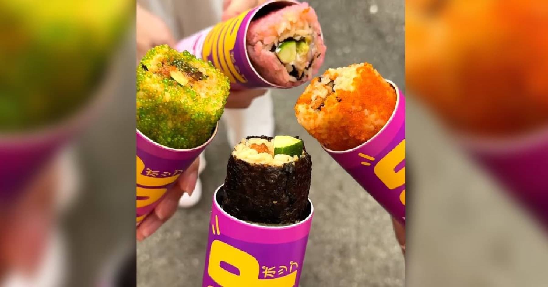 Four purple SushiPOP tubes held together, each with a different maki roll pushed out the top