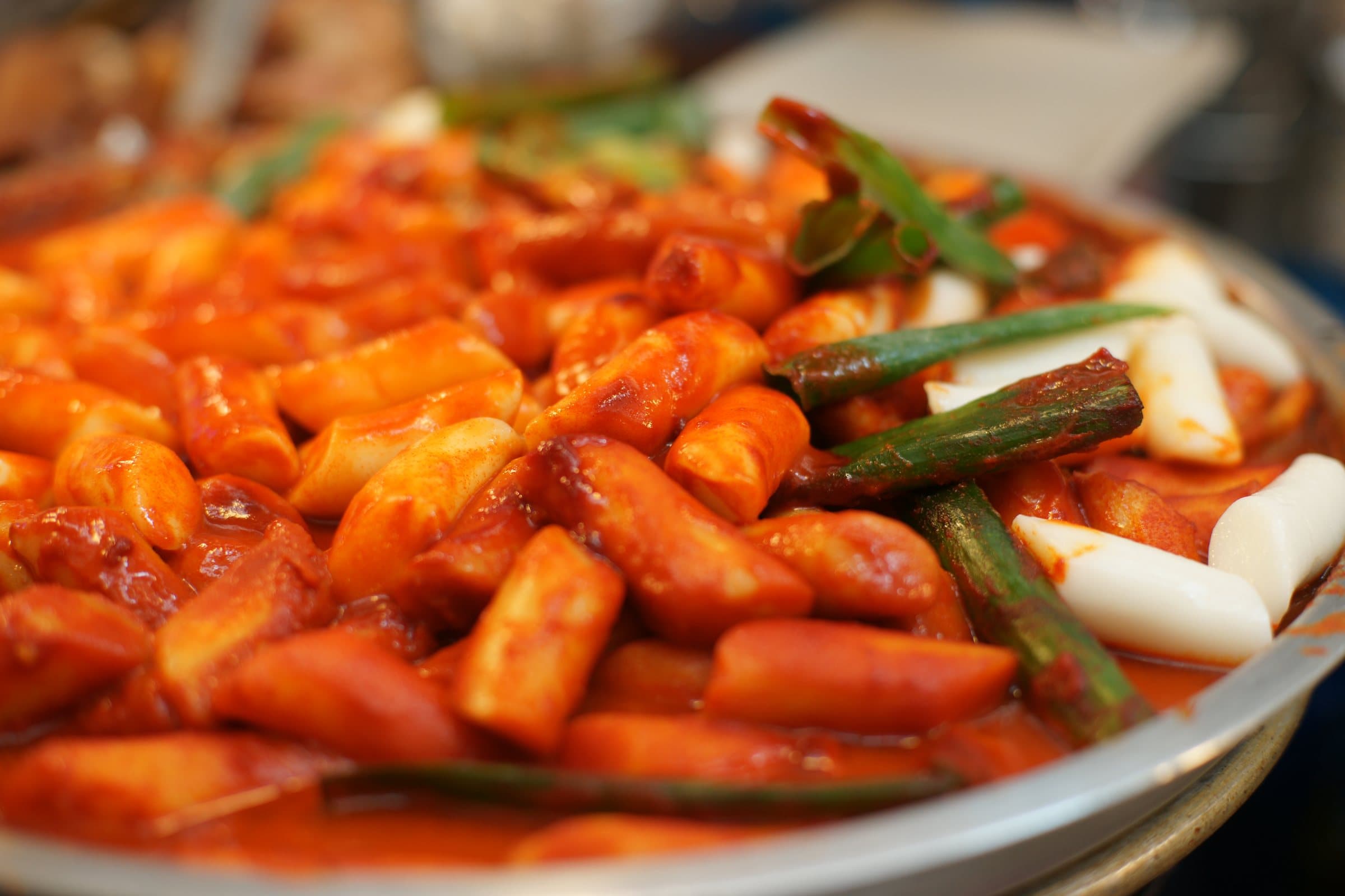 Tteokbokki rice cakes coated in a vivid gochujang-based sauce